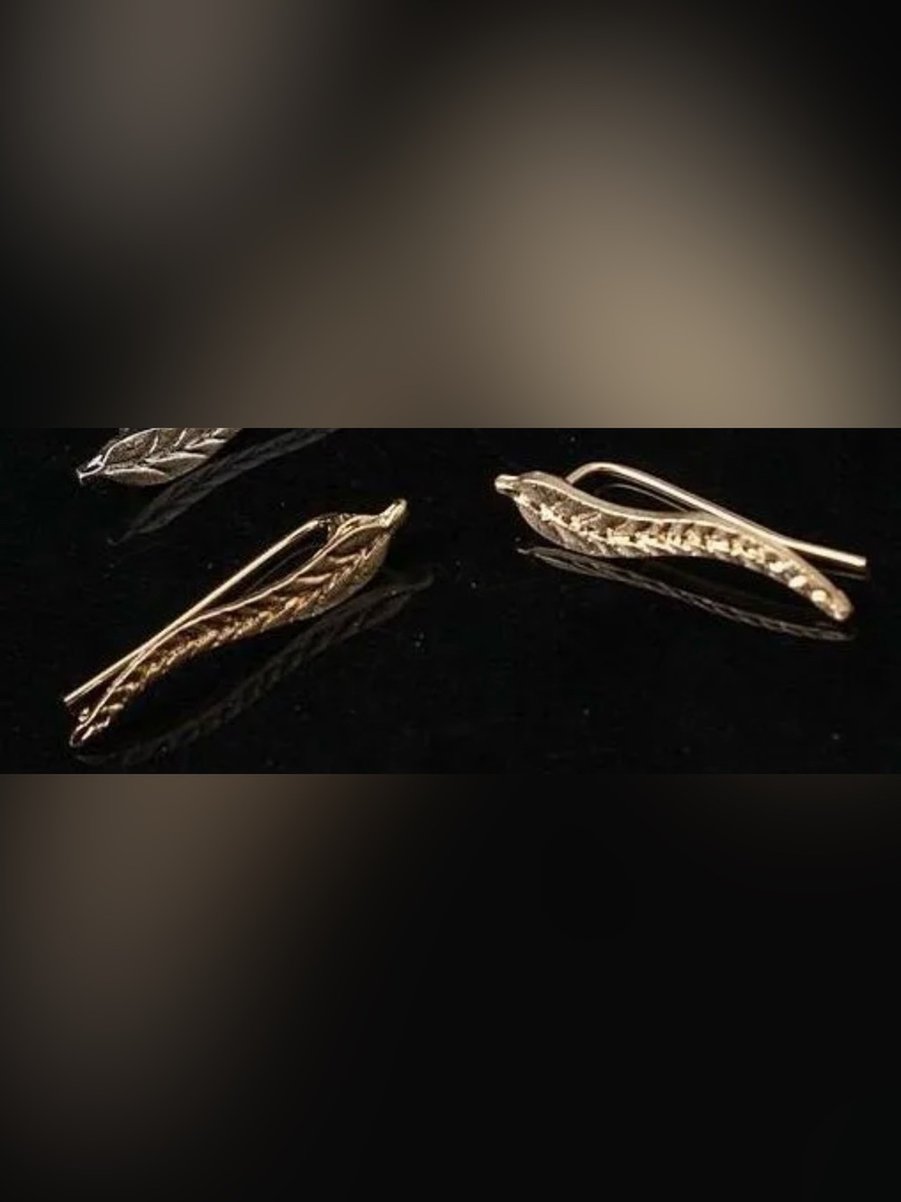 Gold-tone feather earrings with Clear Grip Bumpers